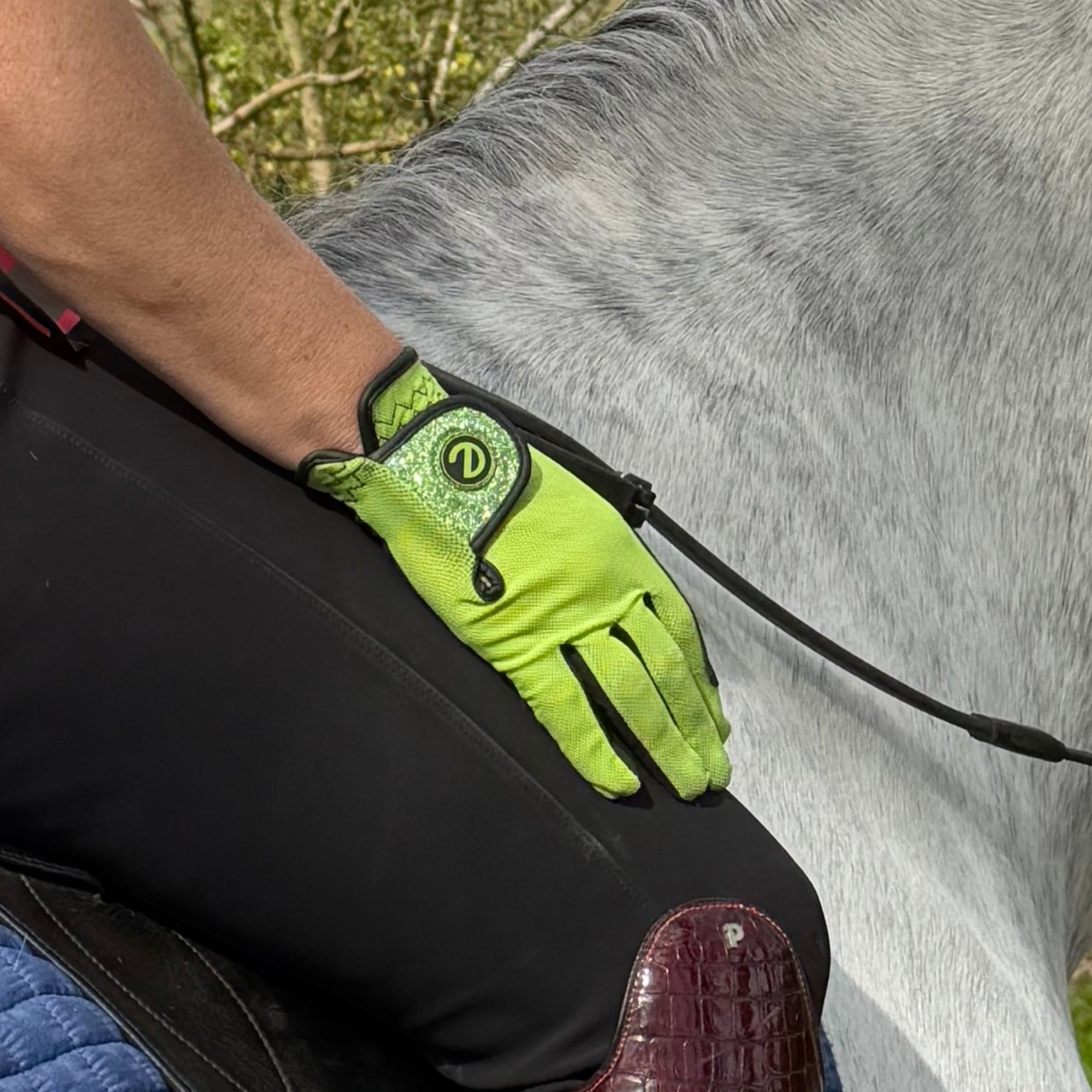 Equestrian on horse wearing Lime green with glitter lightweight riding gloves from eGLOVE
