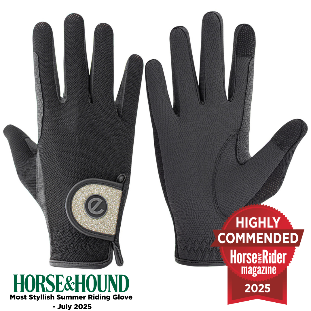 Pair of black equestrian riding gloves with gold glitter along with a Horse&Rider magazine award on a white background